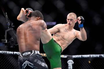 Ian Machado Garry, right, throws a kick to Geoff Neal during their welterweight bout at the UFC ...