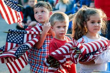 Brayden Austin, left, Gavin Colby, middle, and Brylee Roberge patiently wait with an armful of ...