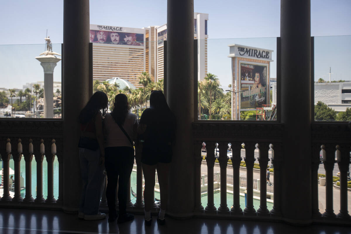 A group of tourists look out onto the Strip from The Venetian, Thursday, June 27, 2024, in Las ...