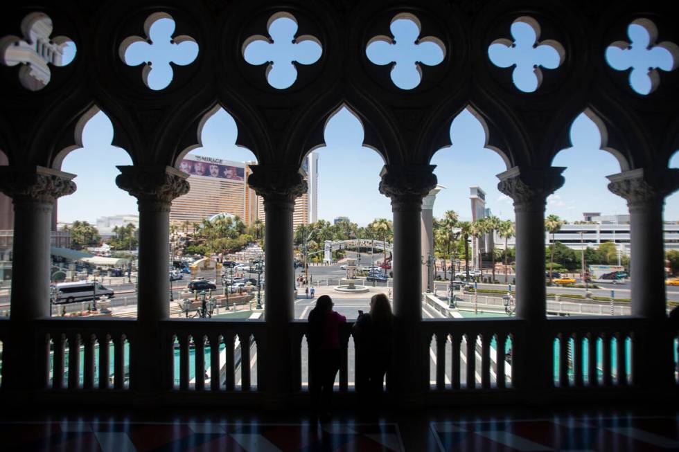A group of tourists look out onto the Strip from The Venetian, Thursday, June 27, 2024, in Las ...