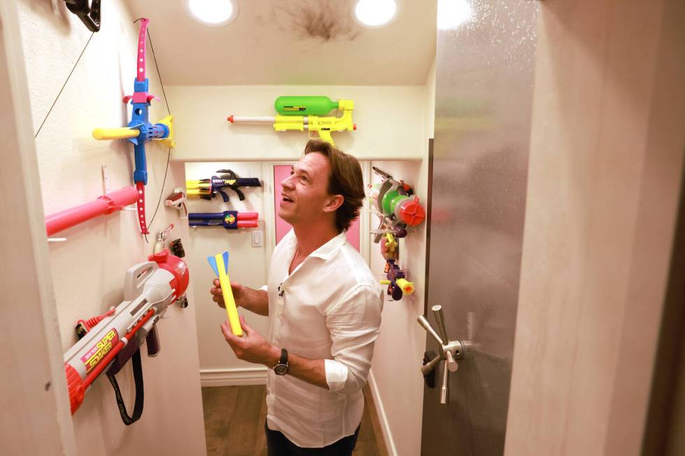 Magician, artist and social media star Justin Flom shows his toy gun safe at the end of a tunne ...