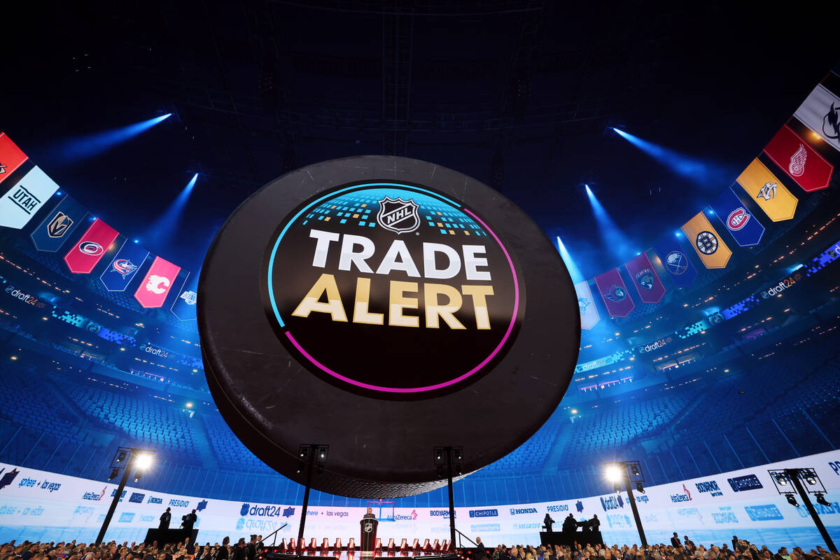 A trade alert flashes on screen during the first round of the NHL hockey draft at Sphere on Fri ...
