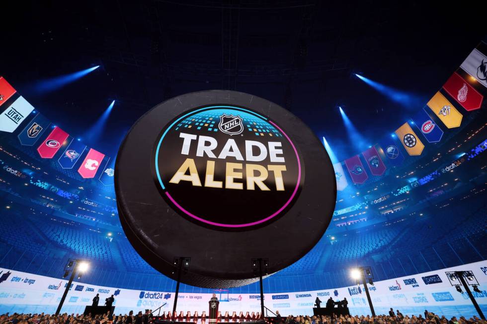 A trade alert flashes on screen during the first round of the NHL hockey draft at Sphere on Fri ...