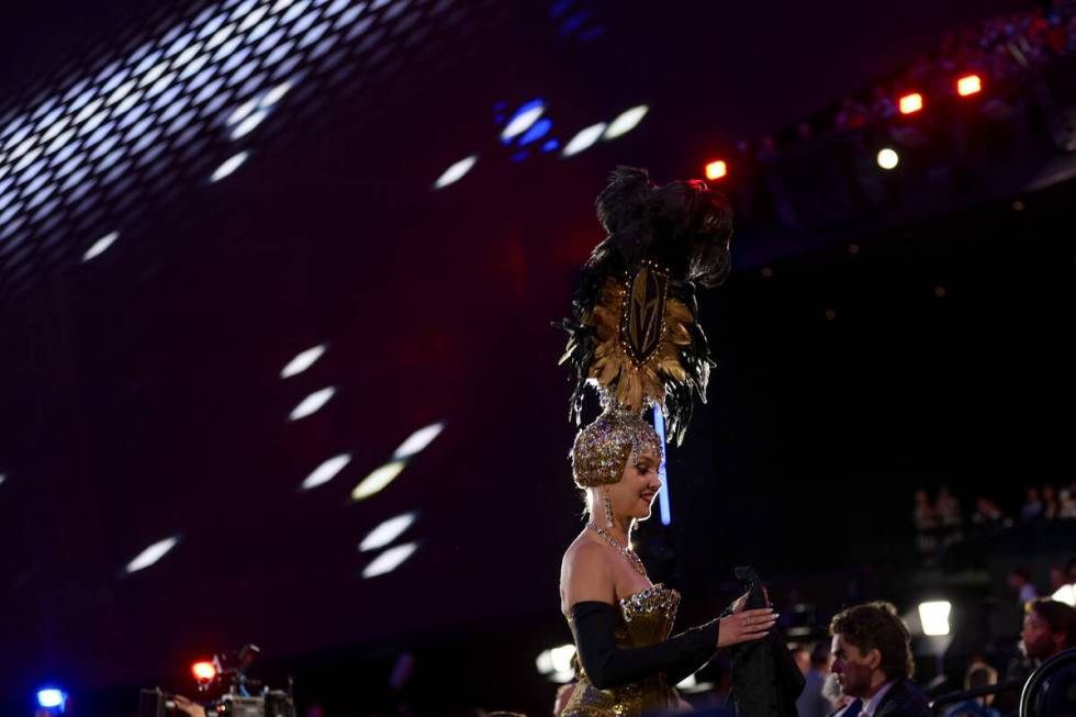 A Vegas Belle returns a draft selection’s jacket during the first round of the NHL hocke ...