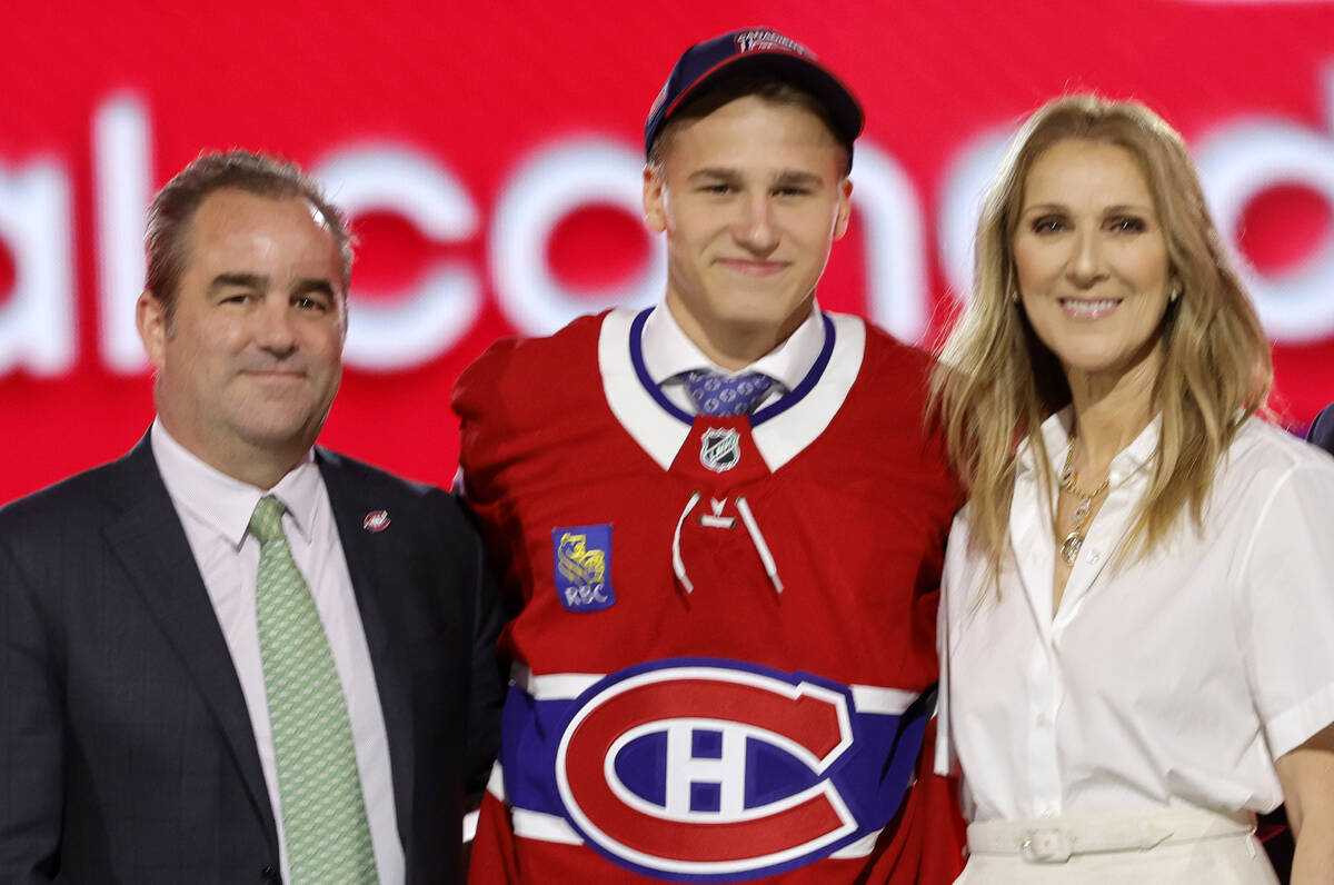 Ivan Demidov, center, poses, after being selected by the Montreal Canadiens during the first ro ...