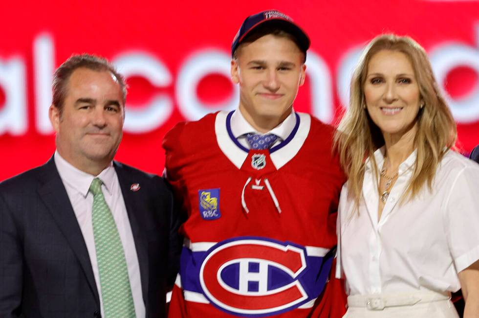 Ivan Demidov, center, poses, after being selected by the Montreal Canadiens during the first ro ...