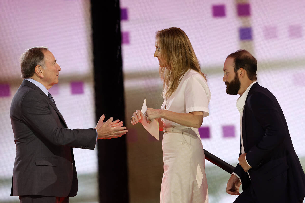 NHL Commissioner Gary Bettman, left, welcomes singer Celine Dion onto the stage during the firs ...