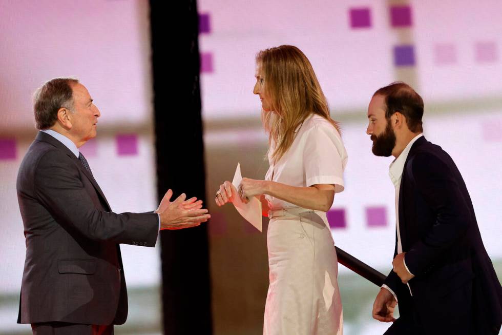NHL Commissioner Gary Bettman, left, welcomes singer Celine Dion onto the stage during the firs ...