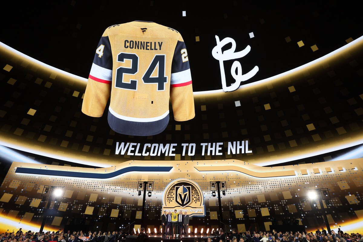 Forward Trevor Connelly poses on stage with Vegas Golden Knights leadership after being selecte ...