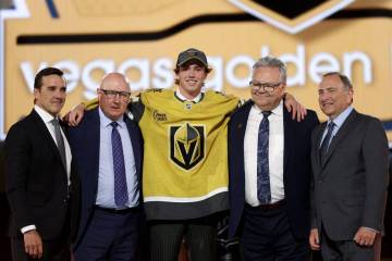 Forward Trevor Connelly poses on stage with Vegas Golden Knights leadership after the team sele ...