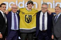 Trevor Connelly, center, poses after being selected by the Vegas Golden Knights during the firs ...