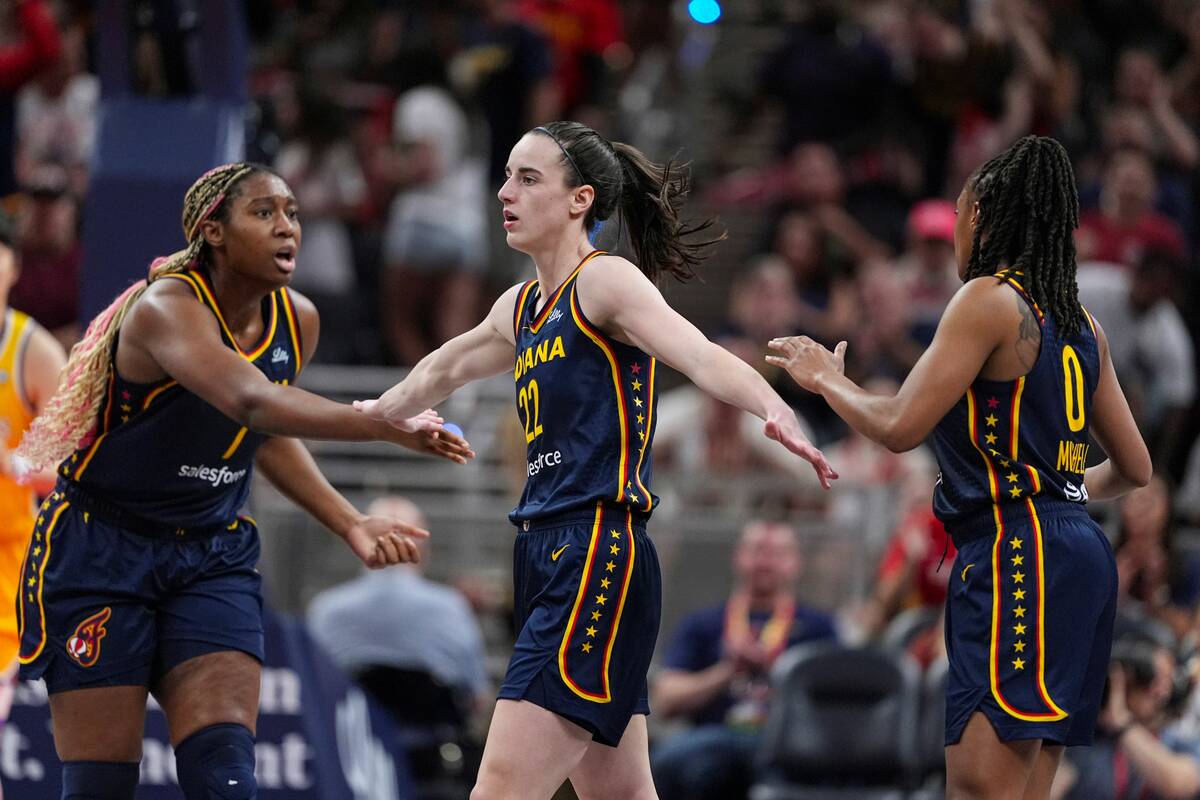 Indiana Fever guard Caitlin Clark (22) is congratulated by Aliyah Boston (7) and Kelsey Mitchel ...