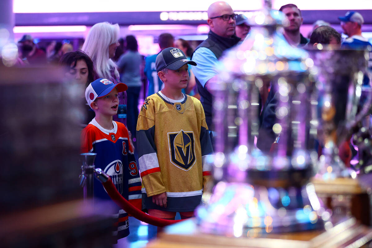 Young fans admire historic hockey trophies during the NHL hockey draft at Sphere on Saturday, J ...