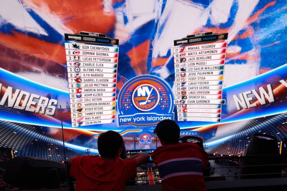 Fans watch as the New York Islanders make a selection during the NHL hockey draft at Sphere on ...