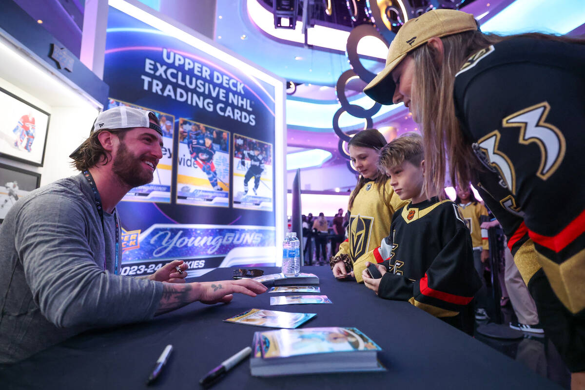 Vegas Golden Knights goaltender Logan Thompson signs autographs for fans Jennifer Anderson, rig ...
