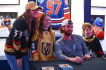 Vegas Golden Knights goaltender Logan Thompson poses for a photo with fans Jennifer Anderson, l ...