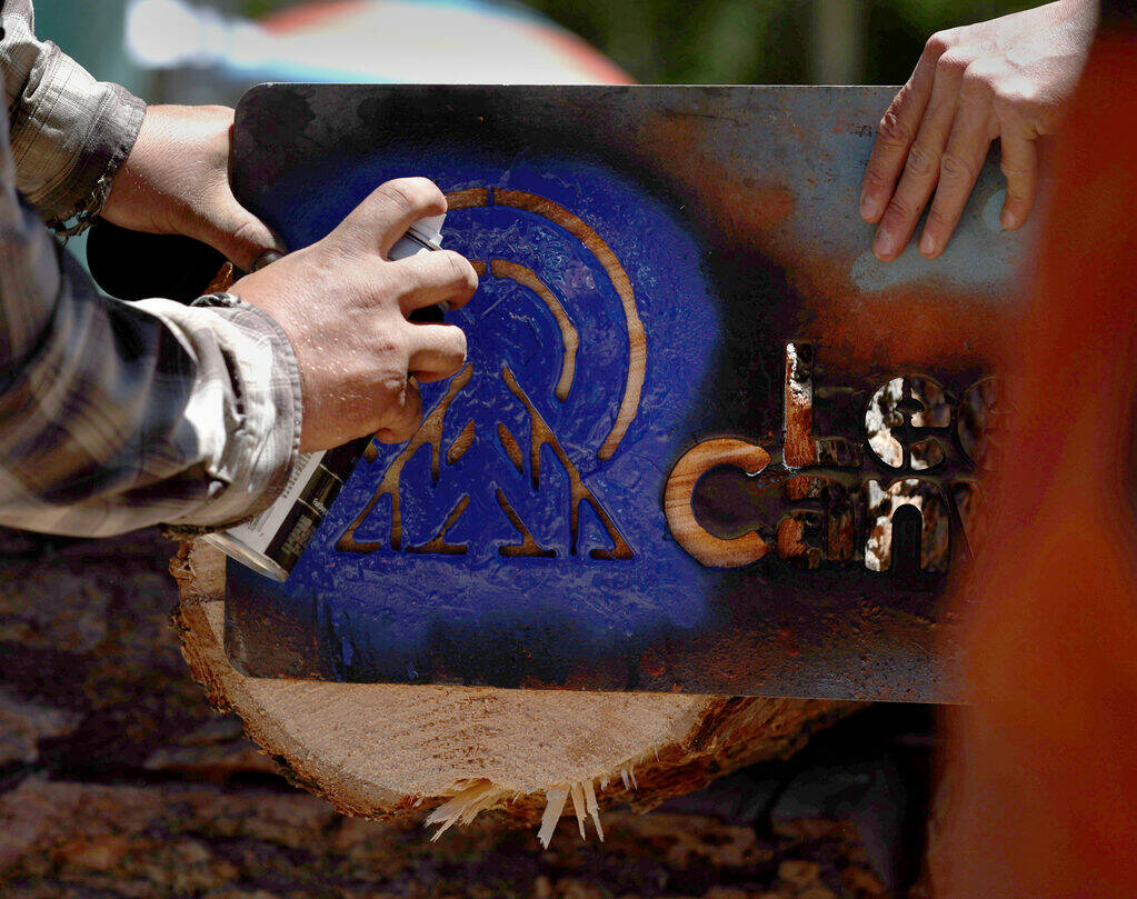 A Lee canyon logo is sprayed on a log for Lee Canyon’s annual Crosscut Log Sawing compet ...