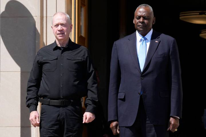 Defense Secretary Lloyd Austin, standing right, and Israeli Defense Minister Yoav Gallant, stan ...