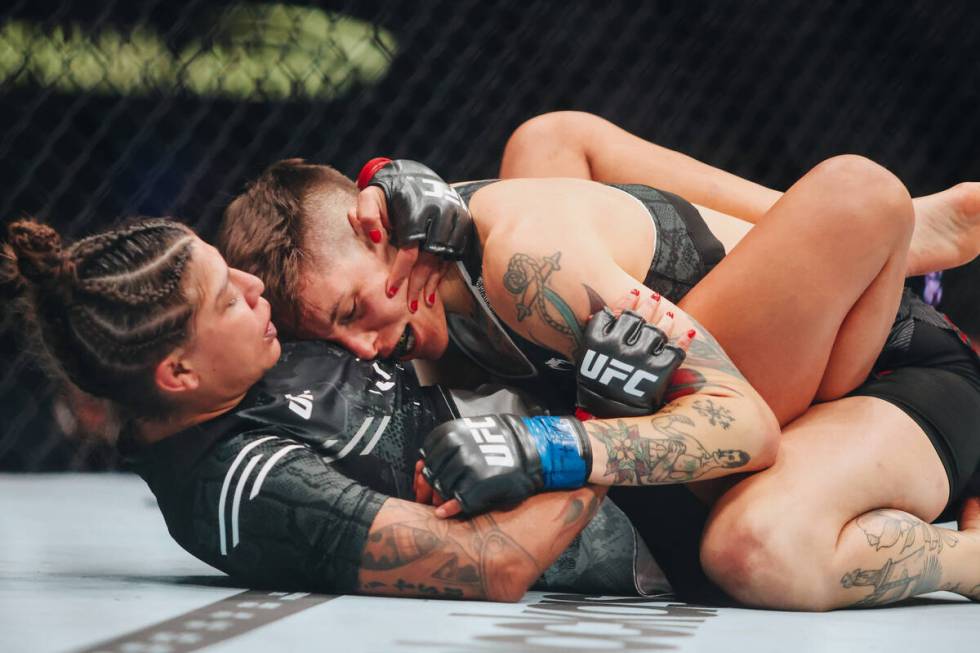 Mayra Bueno Silva, bottom, fights Macy Chiasson during the bantamweight bout at UFC 303 at T-Mo ...