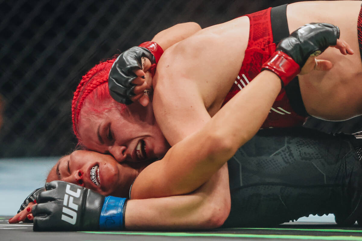 Gillian Roberton, top, pins Michelle Waterson-Gomez to the mat during their strawweight bout at ...