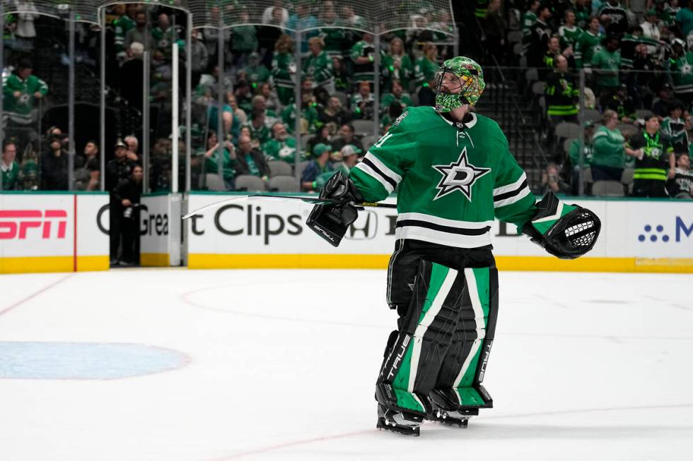 Dallas Stars goaltender Scott Wedgewood looks to the crowd, as spectators throw things onto the ...