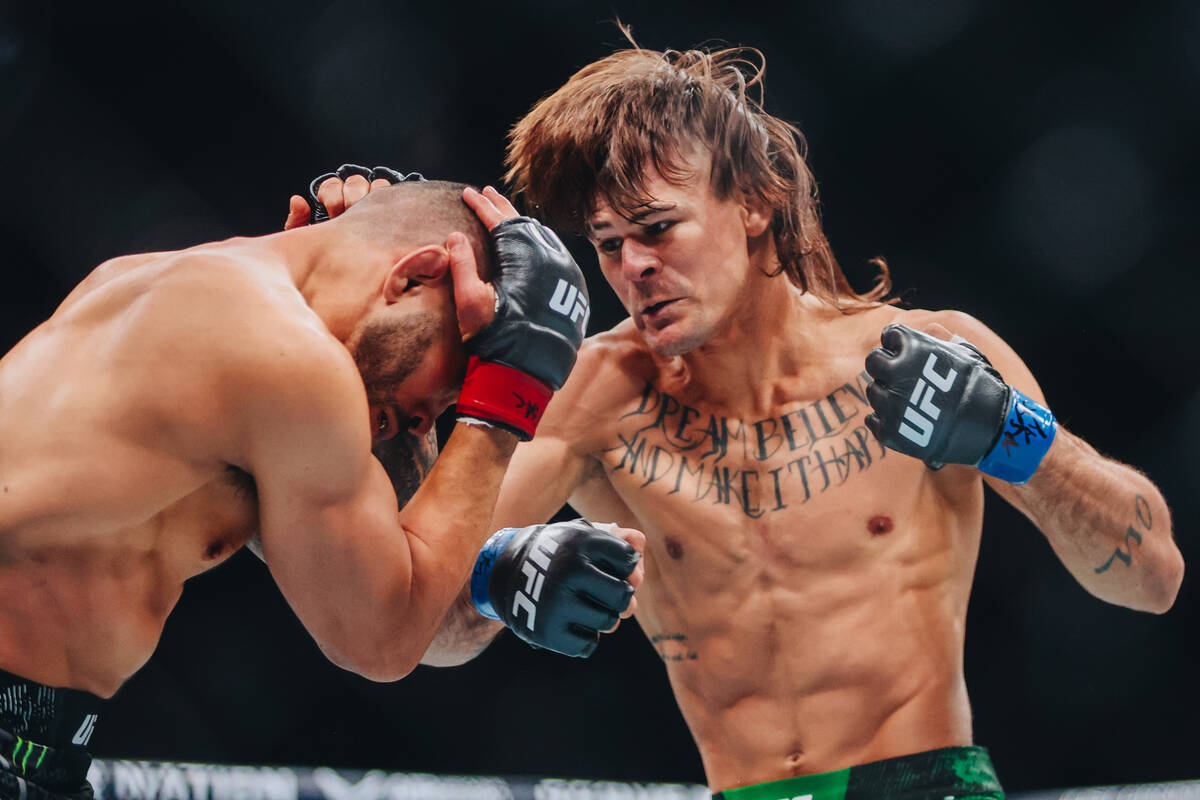 Diego Lopes punches Dan Ige during their catchweight bout at UFC 303 at T-Mobile Arena on Satu ...