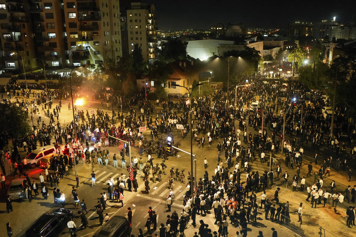 Ultra-Orthodox Jewish men clash with police during a protest against army recruitment in Jerusa ...