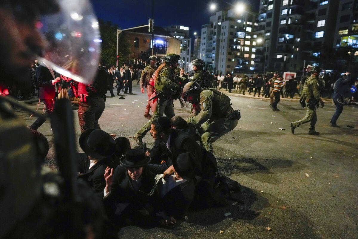 Ultra-Orthodox Jewish men clash with police during a rally against army recruitment in Jerusale ...