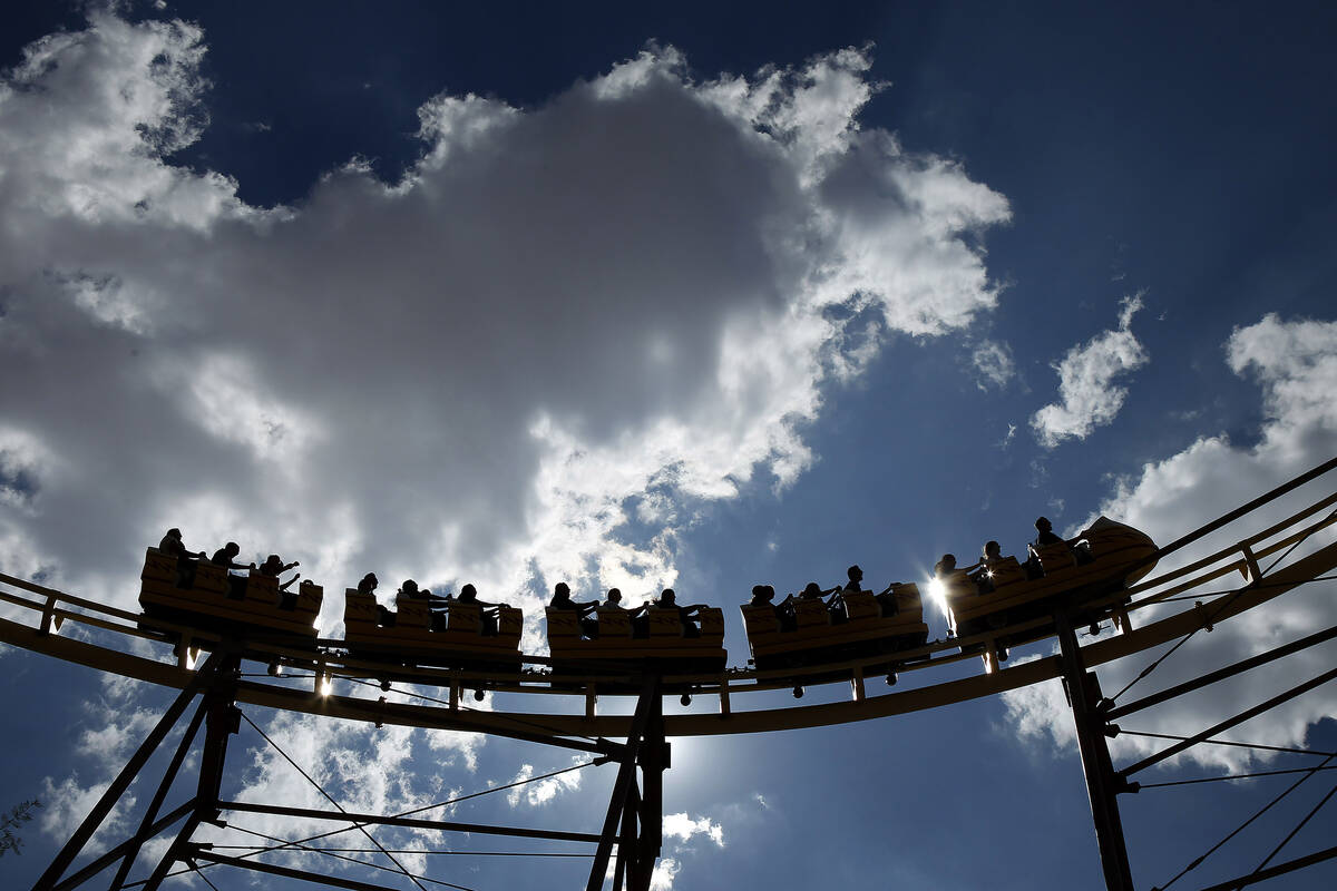 People ride The Desperado roller coaster at Buffalo Bill's in Primm, Nev. Friday, Aug. 16, 2013 ...