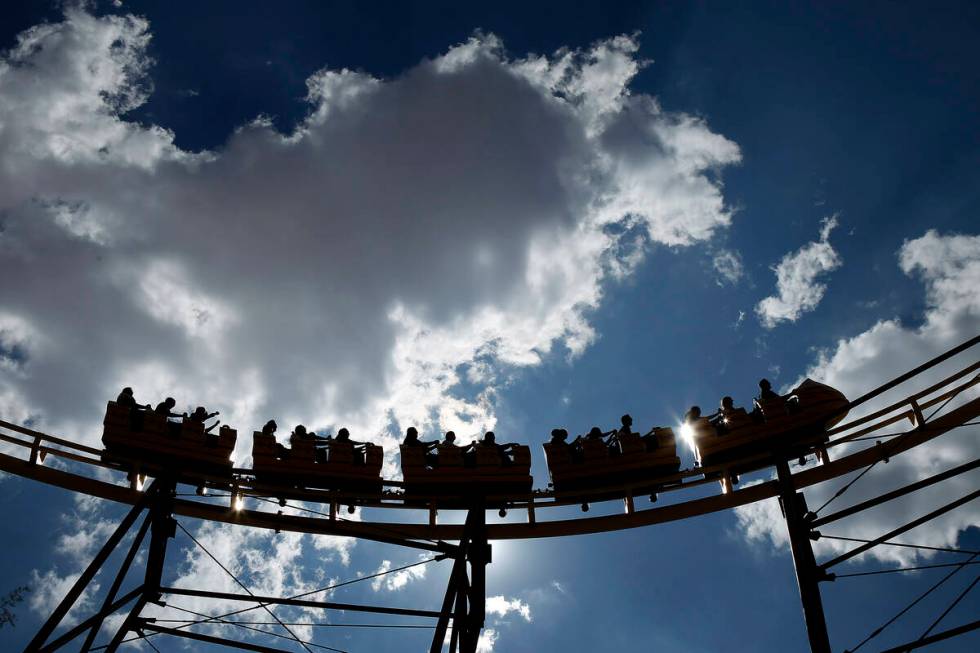 People ride The Desperado roller coaster at Buffalo Bill's in Primm, Nev. Friday, Aug. 16, 2013 ...