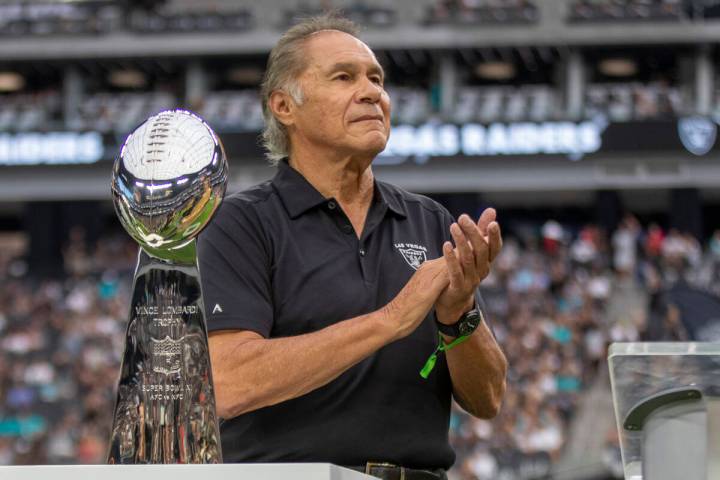 Former Raiders quarterback Jim Plunkett applauds during Tom Flores’ Hall of Fame ring ce ...