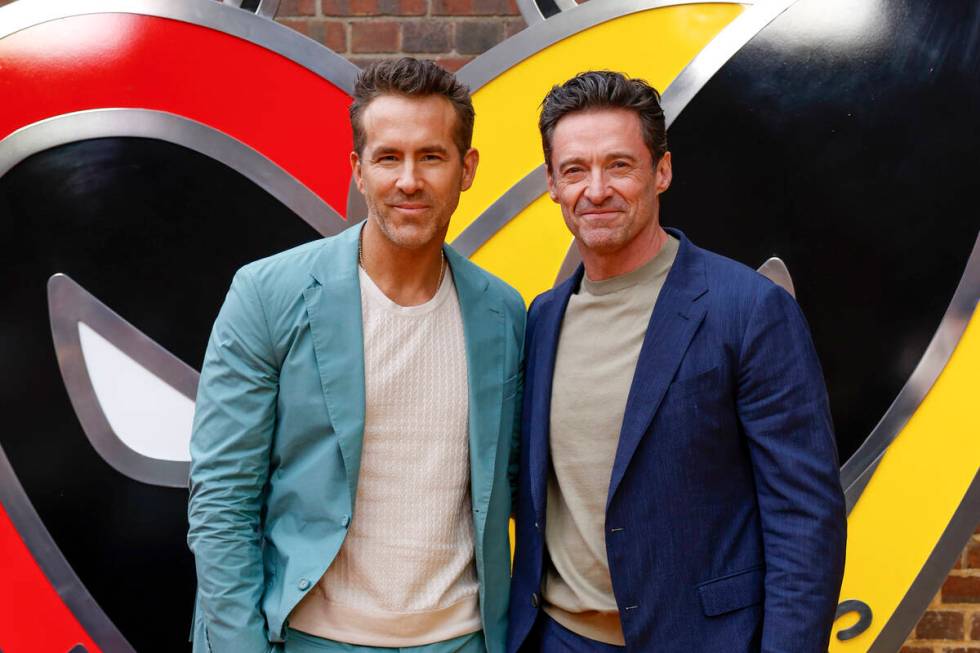 Ryan Reynolds, left, and Hugh Jackman pose for photographers upon arrival at the screening of t ...