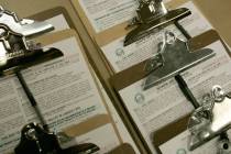 RJ FILE - Clipboards containing voter registration forms are shown on a table at the Clark Coun ...