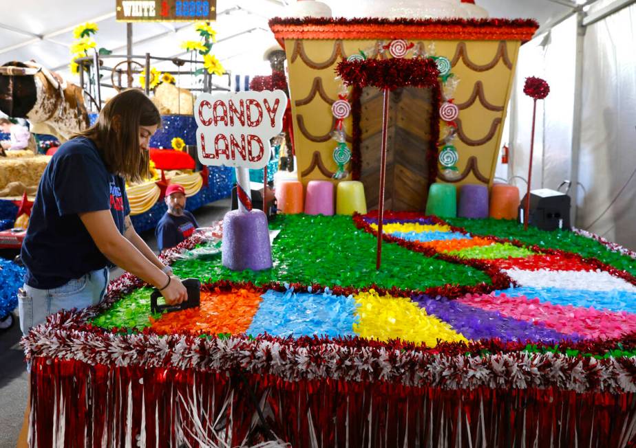 Jordyn Doyle, left, and Dave Bailey, both volunteers, decorate the “Visions of Candy Land” ...