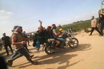 FILE - Palestinians transport a captured Israeli civilian, Noa Argamani, on a motorcycle from s ...