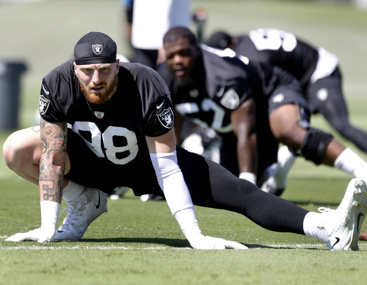 Raiders defensive end Maxx Crosby (98) stretches during an NFL football practice at the Intermo ...
