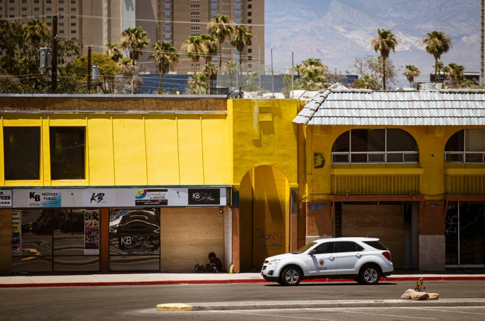 A Clark County vehicle passes a homeless individual in the shade at Commercial Center, one of t ...