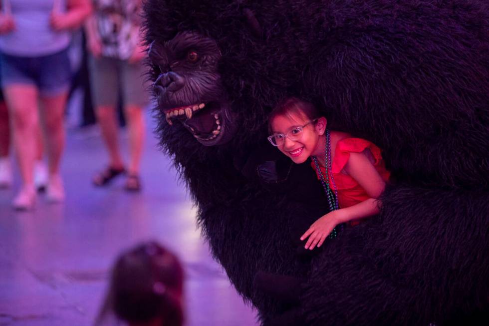 Tourists dance with a gorilla busker at the Fremont Street Experience Monday, July 1, 2024, in ...