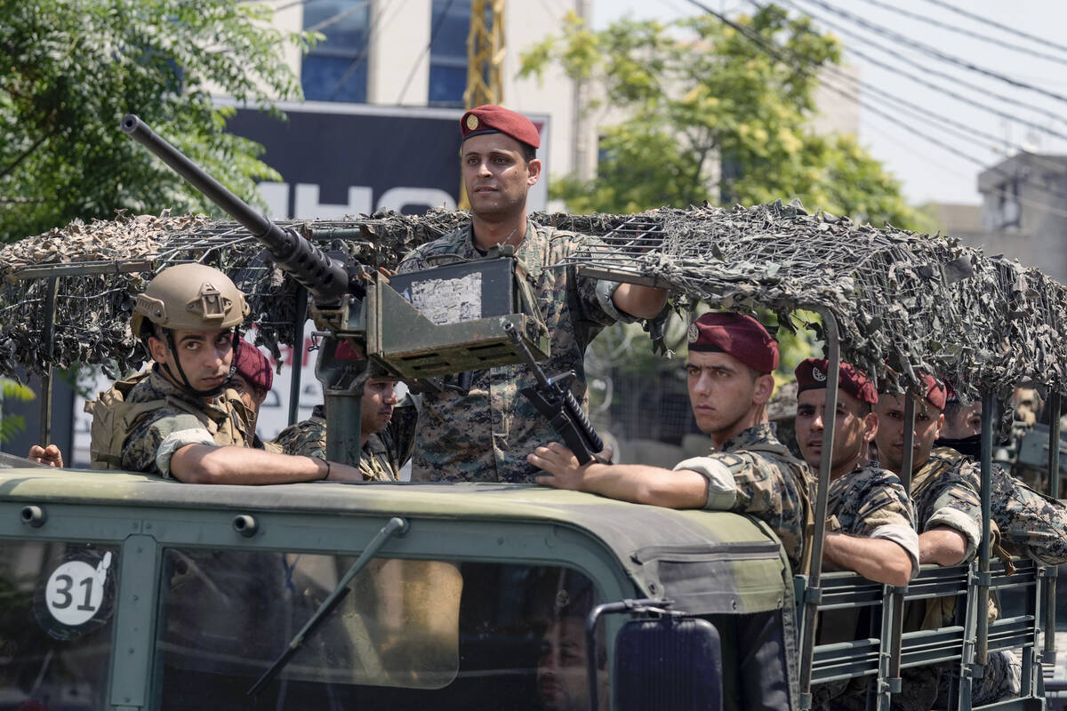 FILE - Lebanese special forces sit in their vehicle as they patrol on a road that leads to the ...
