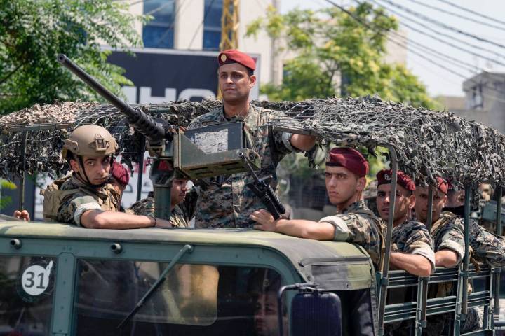 FILE - Lebanese special forces sit in their vehicle as they patrol on a road that leads to the ...