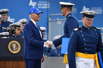 A cadet shakes hands with President Joe Biden after receiving his diploma during the United Sta ...