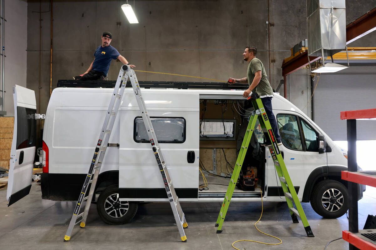 Workers convert a van into a motor home at Noovo manufacturing facility in Las Vegas Thursday, ...