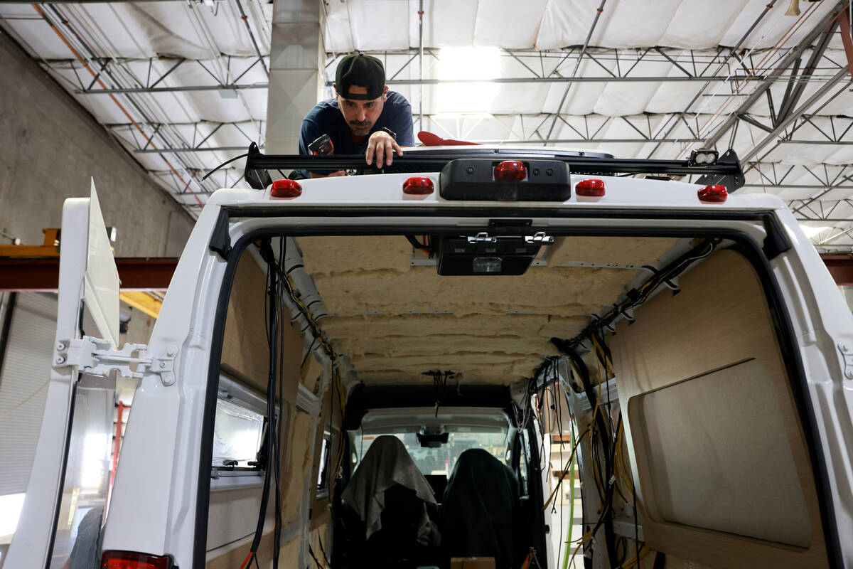 Workers convert a van into a motor home at Noovo manufacturing facility in Las Vegas Thursday, ...