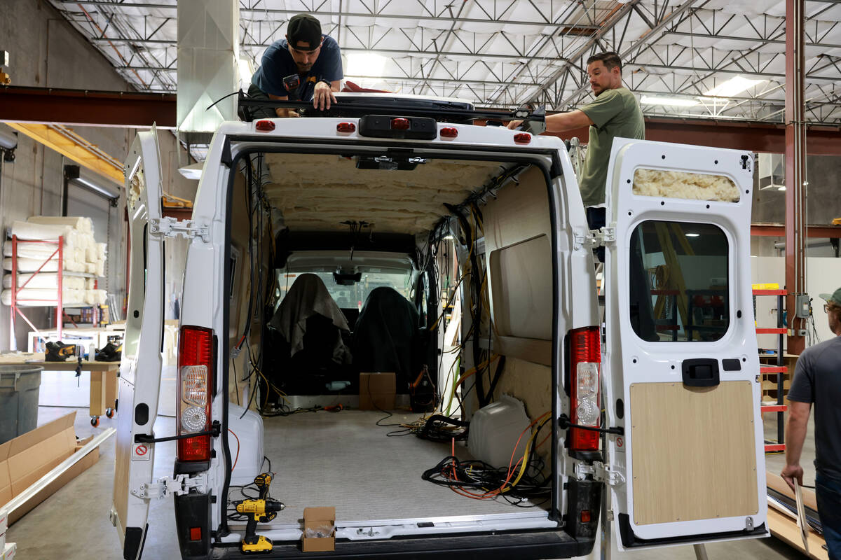 Workers convert a van into a motor home at Noovo manufacturing facility in Las Vegas Thursday, ...