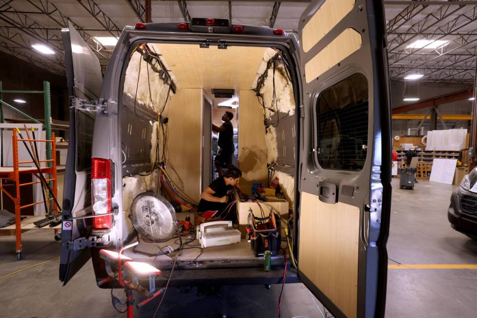 Workers convert a van into a mobile home at Noovo manufacturing facility in Las Vegas Thursday, ...