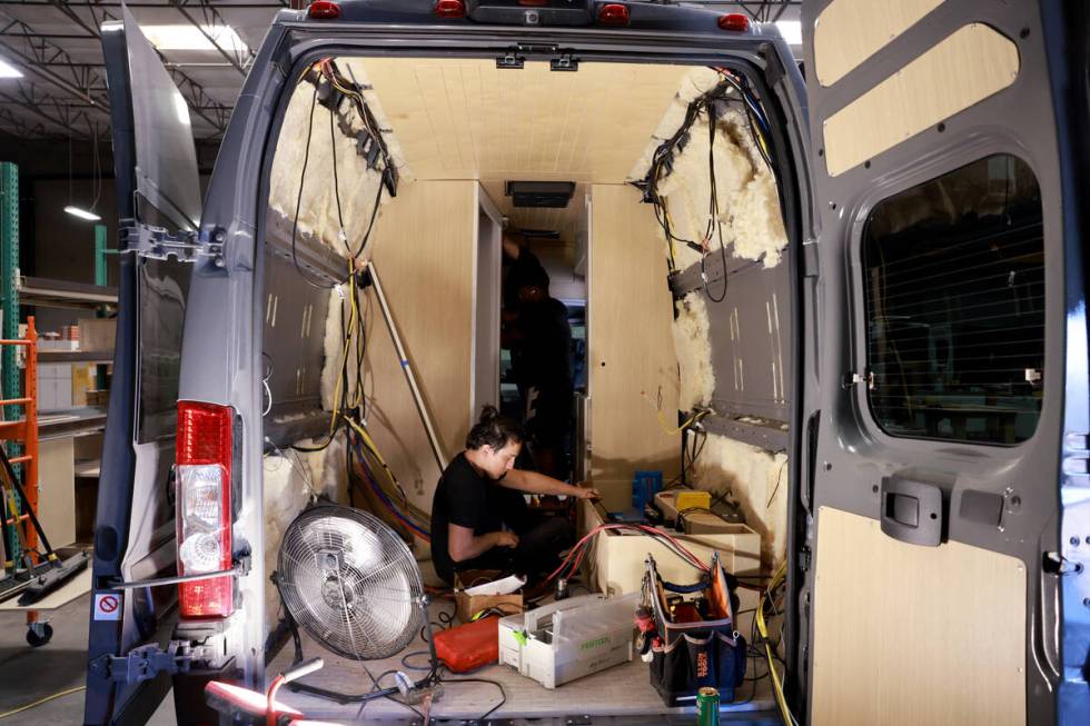 Workers convert a van into a motor home at Noovo manufacturing facility in Las Vegas Thursday, ...