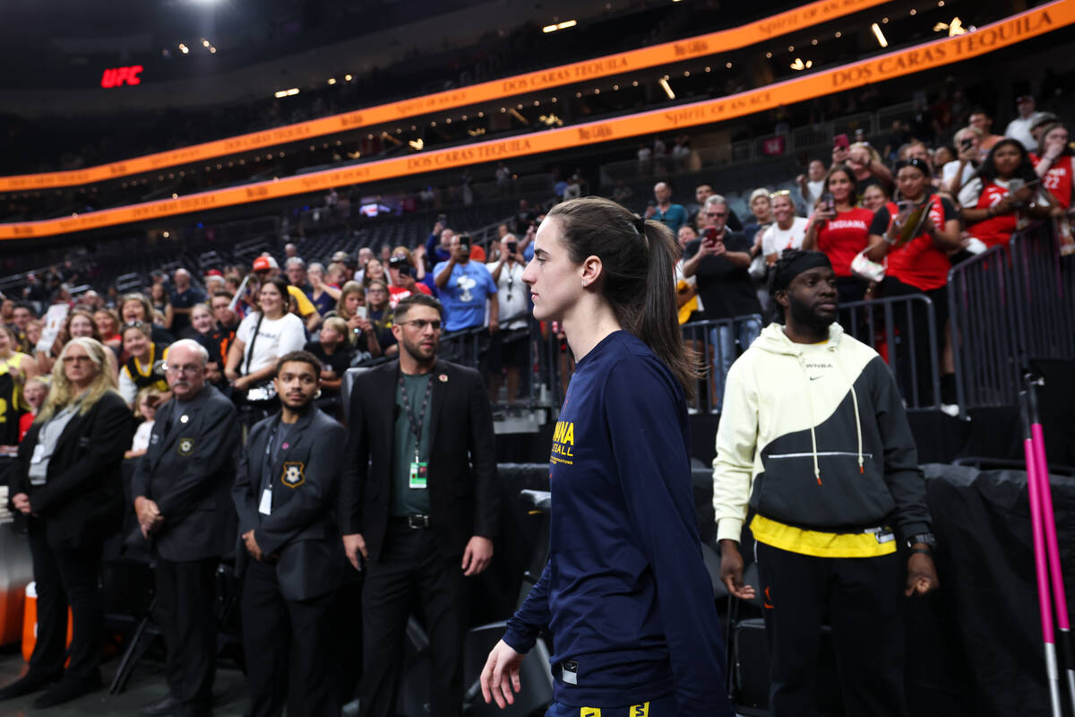 Indiana Fever guard Caitlin Clark walks to the court to warm up before a WNBA basketball game a ...