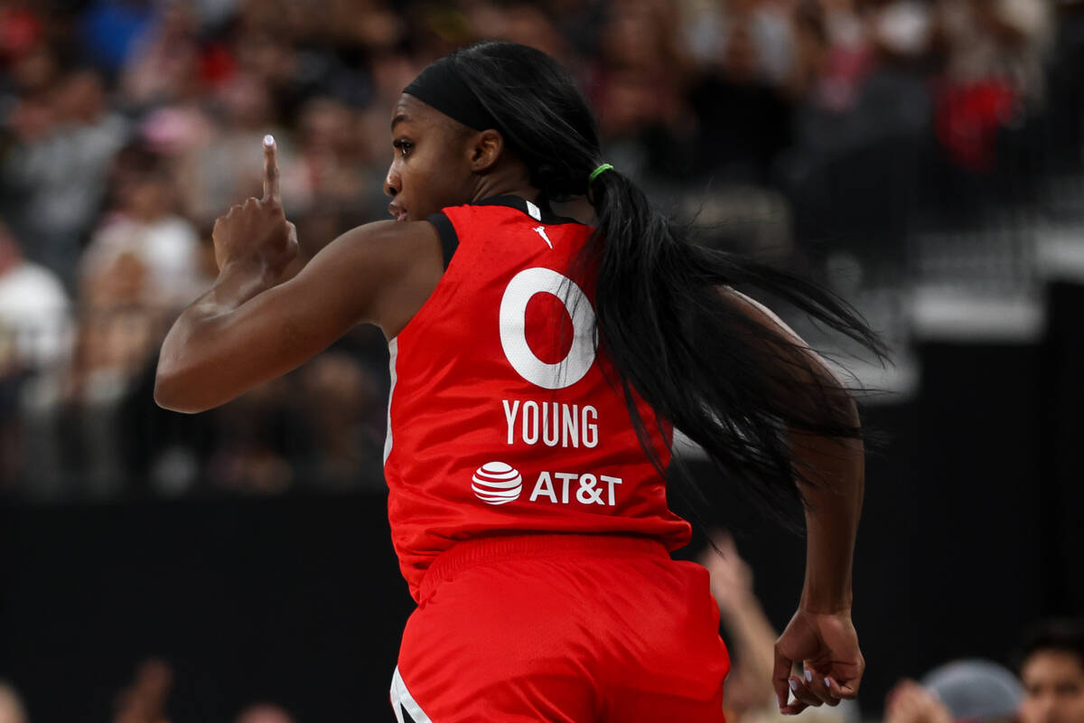 Las Vegas Aces guard Jackie Young (0) celebrates after scoring during the first half of a WNBA ...