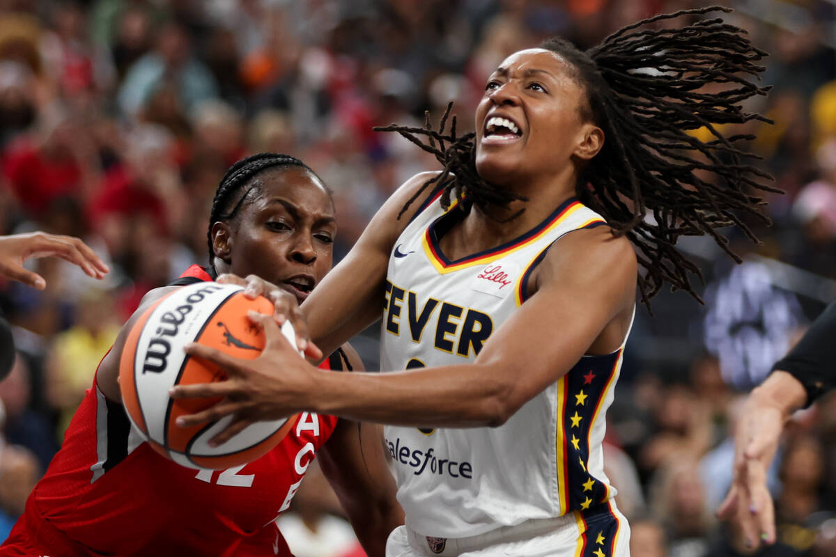 Indiana Fever guard Kelsey Mitchell (0) is blocked by Las Vegas Aces guard Chelsea Gray during ...