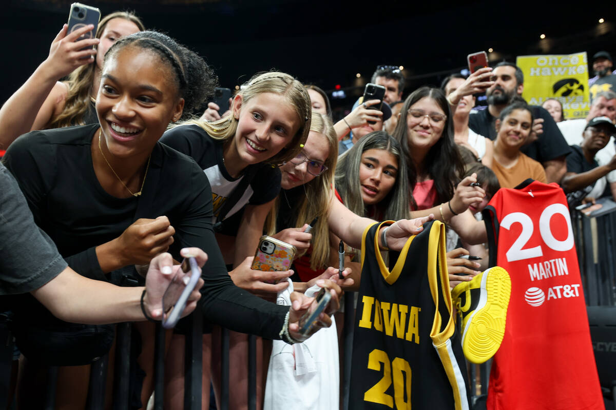 Young fans wait for autographs from the Las Vegas Aces after the Aces beat the Indiana Fever in ...